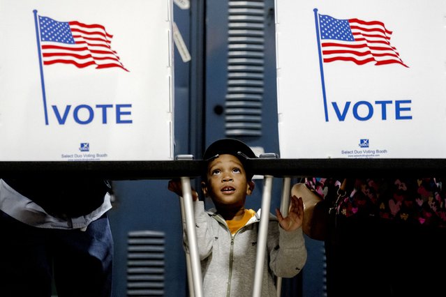 Khalil Wallace,  3, of Detroit waits while his father, Al Wallace, 41, votes at Detroit Fire Department – Station 44 in Detroit, Michigan on November 5, 2024. (Photo by Nic Antaya for The Washington Post)