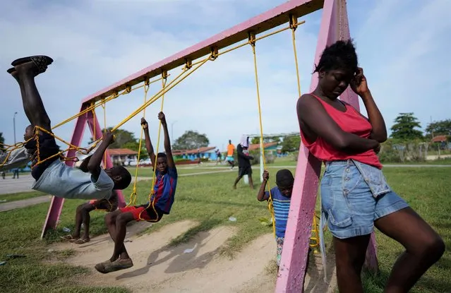 Haitian migrants play at a tourist camping area operated by the Cuban government after their boat bound for the United States strayed off course and washed ashore along the north coast of Cuba instead, in Sierra Morena, Cuba on May 28, 2022. (Photo by Alexandre Meneghini/Reuters)