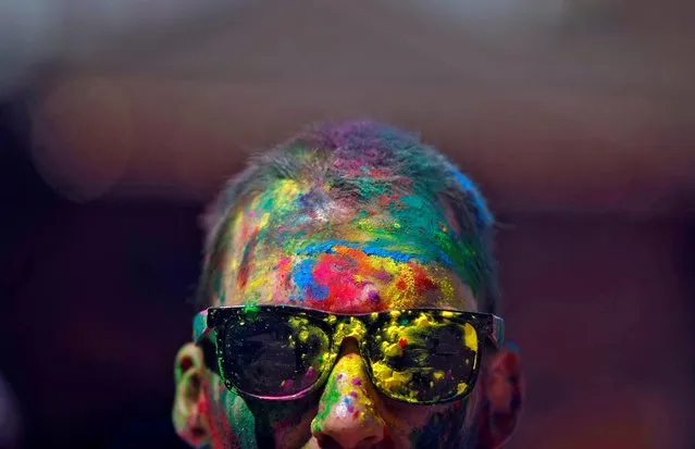 A man with colored powder smeared on his face and head celebrates Holi, the festival of colors, in Kathmandu, Nepal, March 9, 2020. (Photo by Monika Deupala/Reuters)