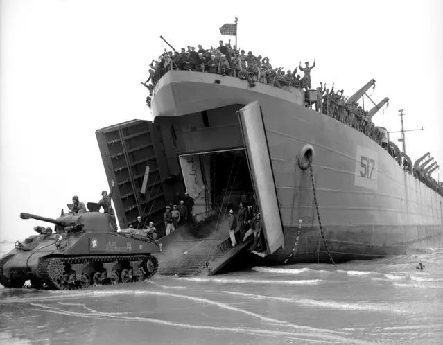 French soldiers driving American tanks from an LST onto a beach somewhere in Normandy on August 15, 1944. The tanks were later driven along the Normandy beach by the same soldiers. (Photo by Peter J. Carroll/AP Photo)