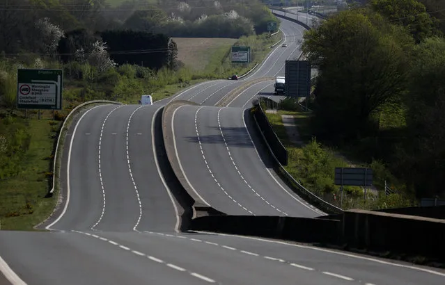 A nearly empty A23 in Slaugham, England, near Brighton due to the coronavirus outbreak and following lockdown on Saturday, April 11, 2020. (Photo by Frank Augstein/AP Photo)
