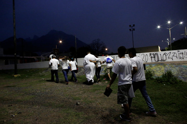 An aspiring Catholic priest Jose Luis Guerra (C), a member of Raza Nueva in Christ, a project of the archdiocese of Monterrey, walks along missionaries during a visit to a neighbourhood in the municipality of Guadalupe, on the outskirts of Monterrey, Mexico, May 30, 2016. (Photo by Daniel Becerril/Reuters)
