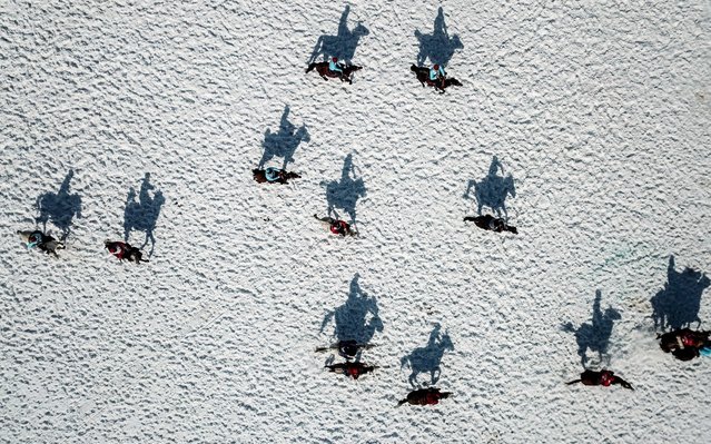 Competitors ride their horses on frozen Lake Cildir , during “Cildir Crystal Lake Winter Festival” in Ardahan, Turkey on February 09, 2019. The second largest lake in eastern Anatolia, Lake Cildir, is hosting the 6th international winter festival as the lake turns into a natural ice rink in winter season. (Photo by Huseyin Yildiz/Anadolu Agency via Getty Images)