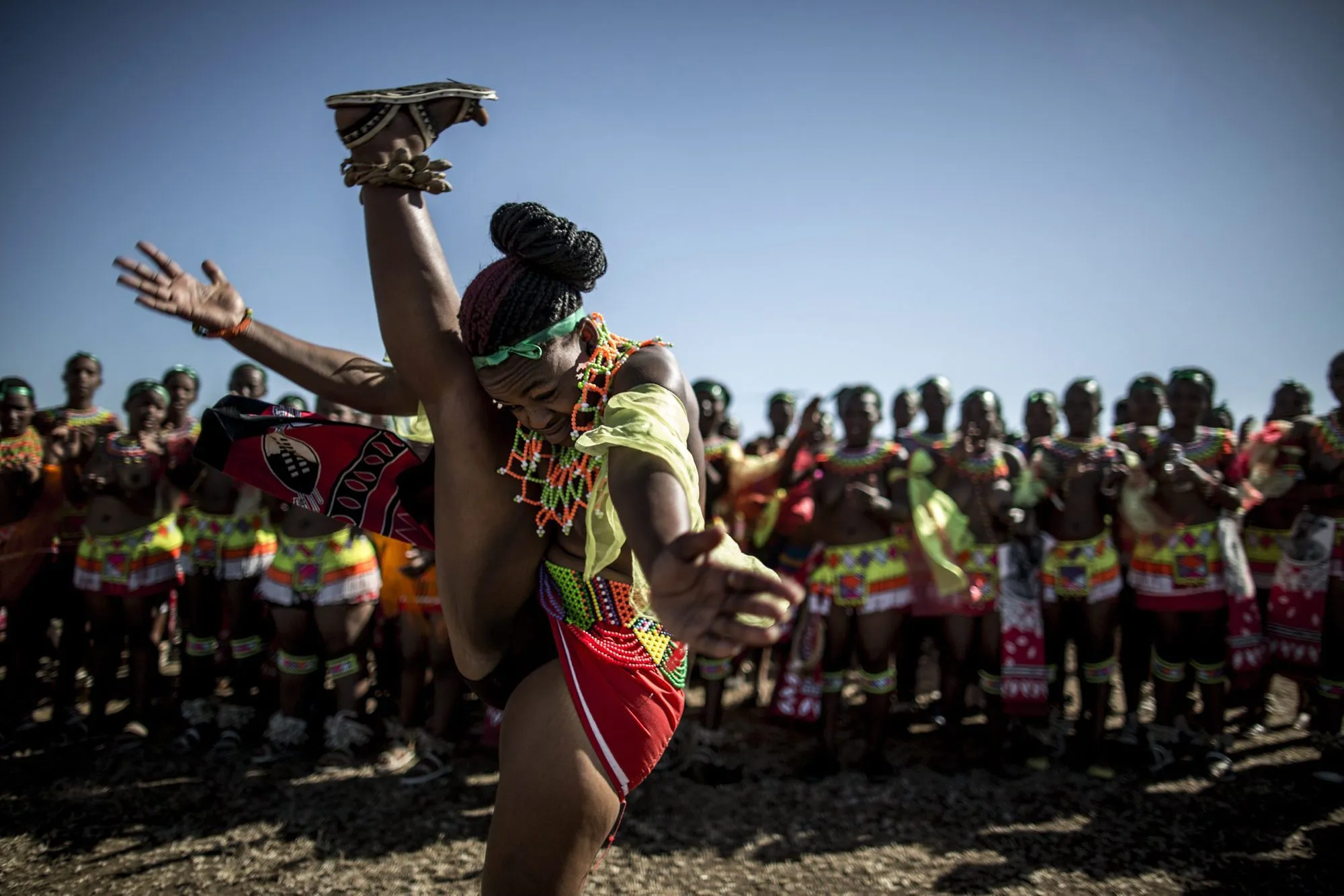A South African maiden dances as others clap during the Reed Dance ceremony...