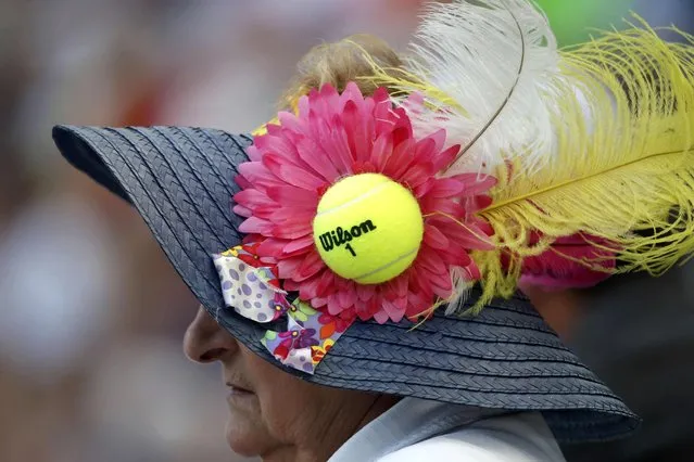 A fan wearing a hat adorned with a tennis ball watches as Jo-Wilfried Tsonga of France plays Marin Cilic of Croatia during their quarterfinals match at the U.S. Open Championships tennis tournament in New York, September 8, 2015. (Photo by Mike Segar/Reuters)