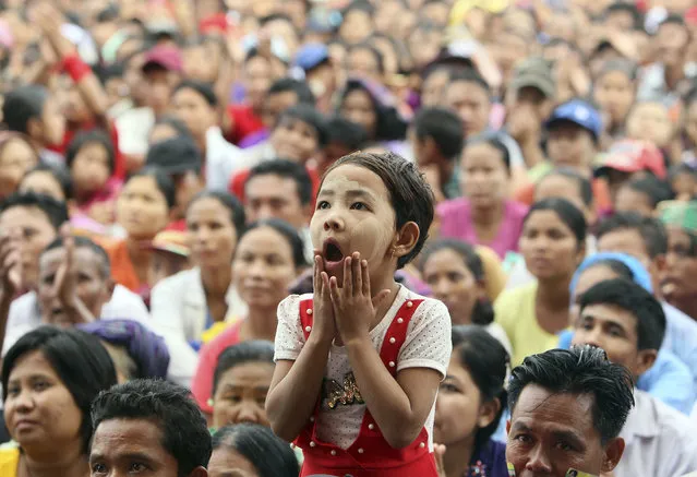 A child reacts during a public rally in support of national leader Suu Kyi Sunday, October 22, 2017, in Naypyitaw, Myanmar.  Myanmar de facto leader Aung San Suu Kyi's government has said that it was willing to take back Rohingya refugees who have fled to southeastern Bangladesh. (Photo by Aung Shine Oo/AP Photo)