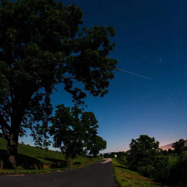 The International Space Station is seen in this 30-second exposure as it flies over Elkton, Virginia, USA, early in the morning on August 1, 2015. (Photo by Bill Ingalls/NASA)