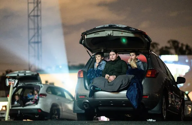 Cinema goers watching a film from their car at the “Skyline Drive” drive-in cinema in Blacktown, in Sydney's West, New South Wales, Australia, 28 May 2020. The Skyline Drive cinema has reopened with increased social distancing and safety measures to help preventing the spread of the coronavirus disease (COVID-19) pandemic. (Photo by James Gourley/EPA/EFE)