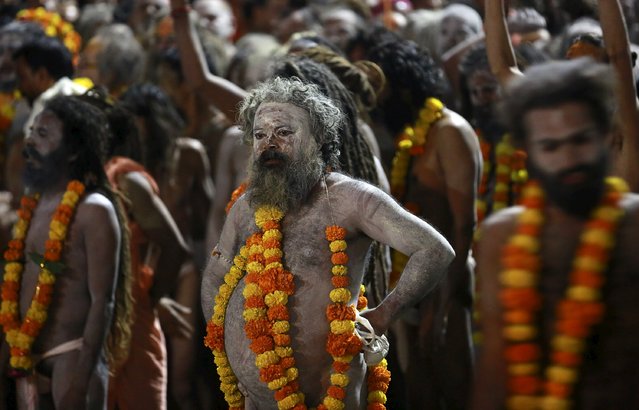 Naga Sadhus, or Hindu holy men, wait during a procession before taking a dip in a holy pond during the second “Shahi Snan” (grand bath) at “Kumbh Mela”, or Pitcher Festival, in Trimbakeshwar, India, September 13, 2015. (Photo by Danish Siddiqui/Reuters)