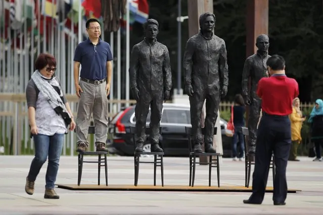 People take pictures with the installation “Anything to Say?”, a bronze sculpture representing whistleblowers Edward Snowden, Julian Assange and Chelsea Manning on the Place des Nations in front of the United Nations European headquarters in Geneva, Switzerland September 14, 2015. According to a press release the work, which weighs more than a ton, is a testimony in favour of freedom of expression and information, without any political controversy. (Photo by Pierre Albouy/Reuters)