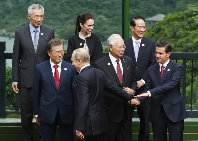 Leaders attend the family photo session at the APEC Summit in Danang, Vietnam Saturday, November 11, 2017. Bottom row from left to right, South Korea's President Moon Jae-in, Russia's President Vladimir Putin, Malaysia's Prime Minister Najib Razak, Mexico's President Enrique Pena Nieto. Top row from left to right,  Singapore's Prime Minister Lee Hsien Loong, New Zealand's Prime Minister Jacinda Ardern, Taiwan's representative James Soong. (Photo by Jorge Silva/Pool Photo via AP Photo)