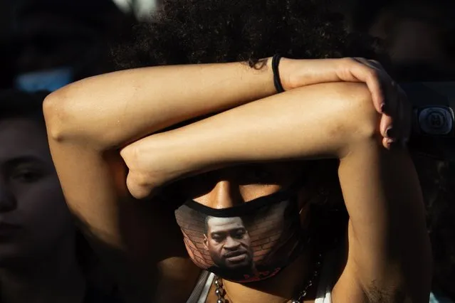 A woman wears a face mask with a portrait of George Floyd, an African-American man killed during his arrest by Minneapolis police officers on 25 May, during a Juneteenth holiday celebration in Los Angeles, California, USA, 19 June 2020. Juneteenth – a portmanteau between the month of June and the word “nineteenth” – marks the day when the last enslaved people in the US were emancipated in 1865 in Galveston, Texas, more then two years after the Emancipation Proclamation of 1863. (Photo by Christian Monterrosa/EPA/EFE)