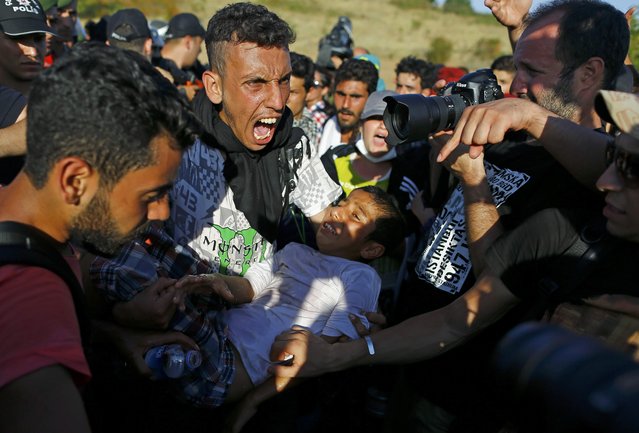 A man reacts as migrants are blocked by police from walking towards the Greece border on a highway near Edirne, Turkey, September 18, 2015. Hundreds of mainly Syrian migrants resumed their march towards western Turkey's border with Greece on Friday after camping for several days on the side of the highway, a Reuters photographer at the scene said. (Photo by Osman Orsal/Reuters)