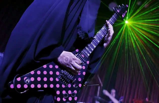 Gisele Marie, a Muslim woman and professional heavy metal musician, plays her Gibson Flying V electric guitar during a concert in Sao Paulo December 16, 2014. (Photo by Nacho Doce/Reuters)