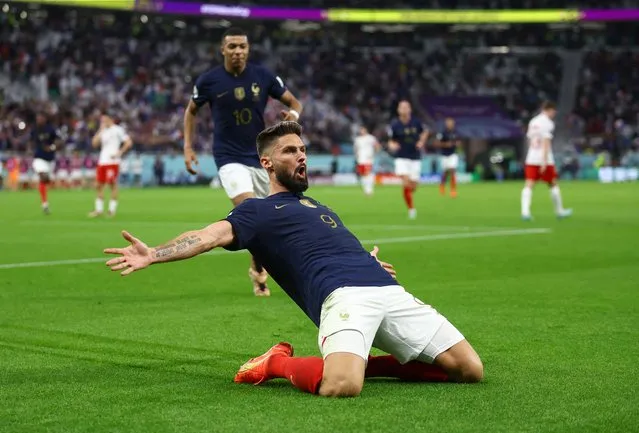Olivier Giroud (R) of France celebrates after scoring the opener during the first half of a World Cup round of 16 football match against Poland at Al Thumama Stadium in Doha, Qatar, on December 4, 2022. (Photo by Hannah Mckay/Reuters)