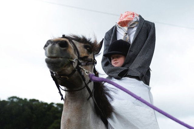 Sophie Hawkshaw, 9, dressed as a Headless Horseman, participates in a lead rein fancy dress competition for riders under 10 years old at an agricultural show, in Athenry, Ireland on May 25, 2025. (Photo by Clodagh Kilcoyne/Reuters)