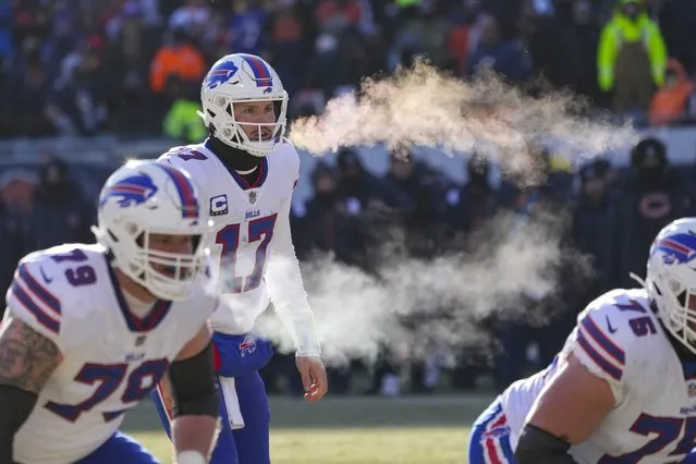 Buffalo Bills quarterback Josh Allen (17) and tackle Spencer Brown (79) exhale before a successful two-point attempt in the second half of an NFL football game against the Chicago Bears in Chicago, Saturday, December 24, 2022. (Photo by Charles Rex Arbogast/AP Photo)