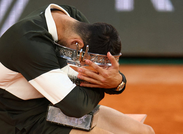 Spain's Carlos Alcaraz celebrates with the French Open trophy after winning the men's singles final against Italy's Jannik Sinner on June 8, 2025. (Photo by Lisi Niesner/Reuters)