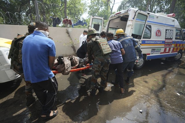 Rescue workers at the site of an airplane that crashed in India's northwestern city of Ahmedabad in Gujarat state, Thursday, June12, 2025. (Photo by Ajit Solanki/AP Photo)