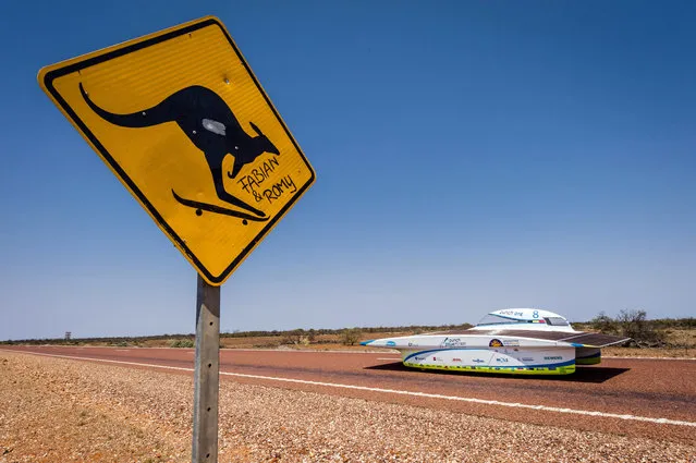 The Punch Powertrain Solar Team car from Belgium competes during the fourth day of the 2015 World Solar Challenge in Coober Pedy, Australia, on Wednesday, October 21, 2015. 45 Solar cars from 25 different countries participate in a 3,000 km race from Darwin to Adelaide. (Photo by Geert Vanden Wijngaert/AP Photo)