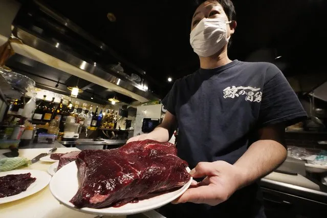 Yuki Okoshi, owner of Japanese restaurant “Kujira no Ibukuro” shows whale meat in Shimbashi, Friday, January 27, 2023, in Tokyo. The Japanese “izakaya” style seafood restaurant started serving whale meat dishes three years ago when higher quality whale meat became available under commercial whaling. (Photo by Eugene Hoshiko/AP Photo)