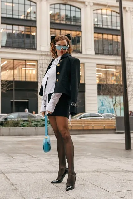 Italian actress Beatrice Grannò wears white ruffled blouse with long sleeves, black jacket, black mini skirt, tights, pnted heels, blue bag, cycle sunglasses outside Patou at La Samaritaine on January 27, 2023 in Paris, France. (Photo by Tonya Matyu)