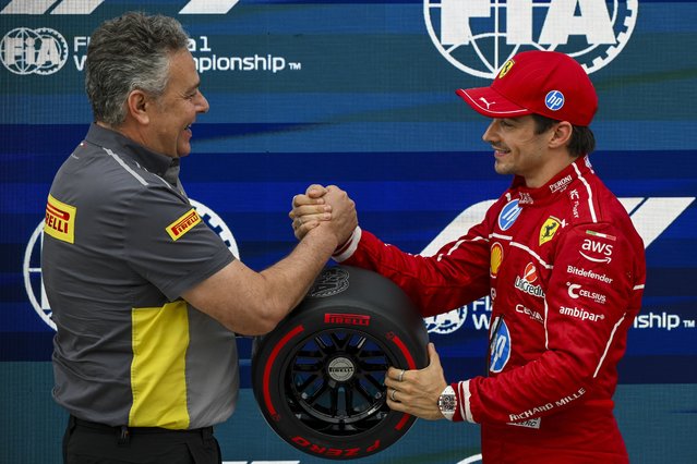 Winner Ferrari driver Charles Leclerc (R) of Monaco shakes hands with motorsport director of Pirelli Mario Isola after the qualifying session for the Formula One Hungarian Grand Prix at the Hungaroring circuit in Mogyorod, Hungary, 02 August 2025, one day ahead of the race. (Phoot by Zsolt Czegledi/EPA)