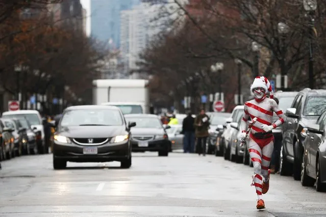 A runner takes part in the 15th annual Santa Speedo Run, a charity run through the streets of the Back Bay, in Boston, Massachusetts December 6, 2014. (Photo by Brian Snyder/Reuters)