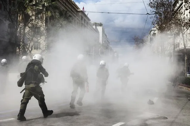 Riot police operate against demonstrators during clashes in Athens, Greece, Sunday, March 5, 2023. Thousands protesters, take part in rallies around the country for fifth day, protesting the conditions that led the deaths of dozens of people late Tuesday, in Greece's worst recorded rail accident. (Photo by Yorgos Karahalis/AP Photo)