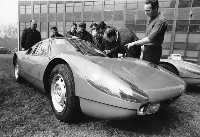 A group of mechanics examine the new Porsche Gran Turismo Type 904, designed with a boxer-engine and a polyester plastic body in Ludwigshafen, Germany on March 10, 1964. (Photo by AP Photo)