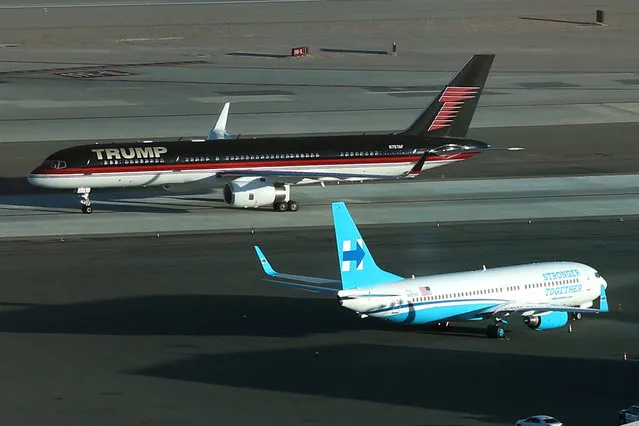 U.S. Republican presidential nominee Donald Trump's campaign plane (rear) passes U.S. Democratic presidential nominee Hillary Clinton's campaign plane as it lands in Las Vegas, Nevada, U.S. October 18, 2016. (Photo by Lucy Nicholson/Reuters)