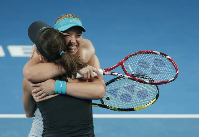 Martina Hingis of Switzerland and Sabine Lisicki (facing camera) of Germany embrace after winning the women's doubles final match at the Brisbane International tennis tournament in Brisbane, January 10, 2015. (Photo by Jason Reed/Reuters)
