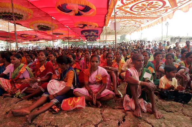 Tribal women listen to BJP state general secretary Vinod Tawde at a public meeting in Talasari near the Maharashtra-Gujarat border on Monday afternoon. Talasari is home to adivasis who belong to the Warli tribe or are fisherfolk (kolis). (Photo by Prasad Gori/Hindustan Times via Getty Images)