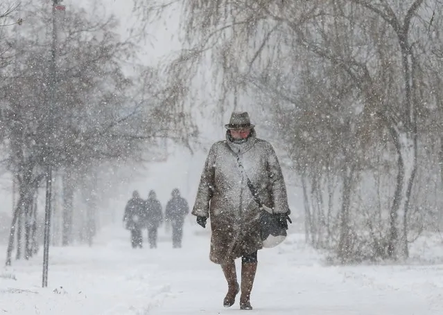 A pedestrian walks along a street during snowfall in Kyiv, Ukraine on December 23, 2020. (Photo by Valentyn Ogirenko/Reuters)
