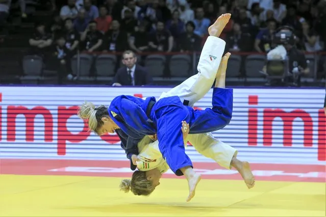 Distria Krasniqi of Kosovo, top, and Odette Giuffrida, of Italy compete during their women's -52kg bronze medal judo match at the World Judo Championships in Doha, Qatar, Monday, May 8, 2023. (Photo by Hussein Sayed/AP Photo)