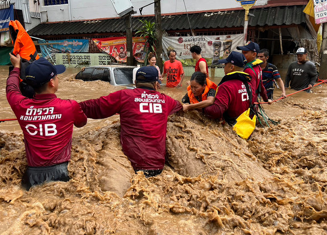 A handout photo made available by Central Investigation Bureau (CIB) shows CIB personnel helping flood victims during flooding due to heavy rain in urban areas of Chiang Rai Province, northern of Thailand, 12 September 2024. At least nine people have died, several are missing, and more than 22,400 households have been affected by flash floods and landslides caused by the impact of Typhoon Yagi in several northern provinces of Thailand, according to the Department of Disaster Prevention and Mitigation of Thailand. (Photo by Central Investigation Bureau/EPA/EFE)