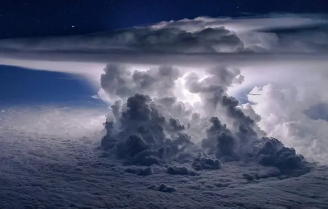 Storm erupts over Pacific Ocean as plane zooms past at 37,000 ft. The amazing picture shows a massive cloud erupting against a starry night sky as the off-duty airman Santiago Borja flew over the Pacific near Panama City. He had just moments to take the breathtaking snap as the Boeing 767 zoomed by at 37,000 ft on its way from North America to Ecuador. He also had take the picture perfectly in time with the flash of lightning to capture the storm in all its glory. (Photo by Santiago Borja/Solent News)