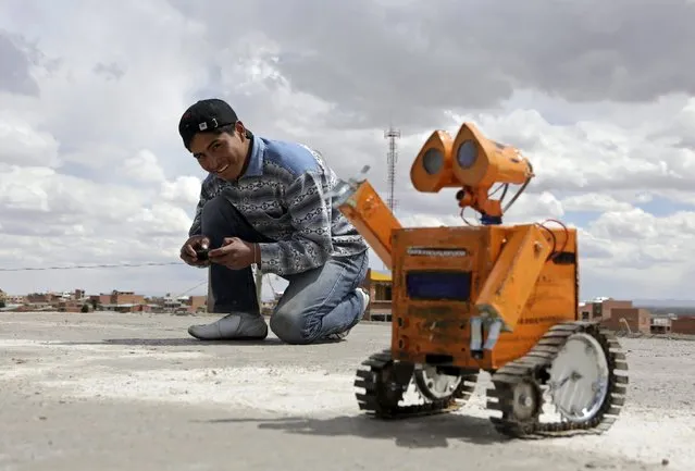 A replica of the Wall-E character is remotely controlled with a mobile phone by Bolivian student Esteban Quispe, 17, in Patacamaya, south of La Paz, December 10, 2015. (Photo by David Mercado/Reuters)