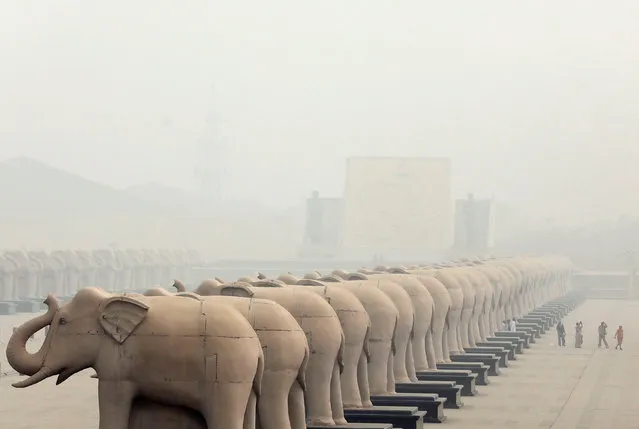 People walk inside the Ambedkar Memorial Park amidst heavy smog in Lucknow, India, November 7, 2016. (Photo by Pawan Kumar/Reuters)