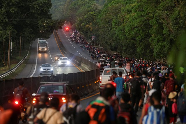 Migrants walk in a caravan bound for the northern border with the U.S., in Huehuetan, Mexico on January 26, 2025. (Photo by Damian Sanchez/Reuters)