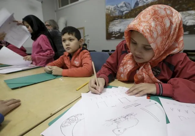 Refugee children attend class in a camp at a hotel touted as the world's most northerly ski resort in Riksgransen, Sweden, December 15, 2015. (Photo by Ints Kalnins/Reuters)