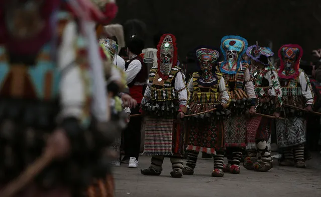 Masked Bulgarian dancers take part in the second competition day of the 24th International Festival of Masquerade Games “Surva” in the town of Pernik, Bulgaria Saturday, January 31, 2015. (Photo by Valentina Petrova/AP Photo)