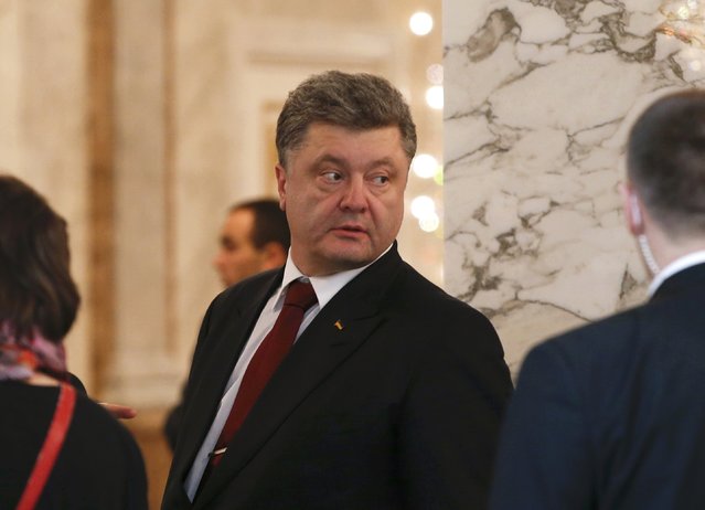 Ukraine's President Petro Poroshenko (C) looks on as he attends a peace summit to resolve the Ukrainian crisis in Minsk, February 12, 2015. (Photo by Grigory Dukor/Reuters)
