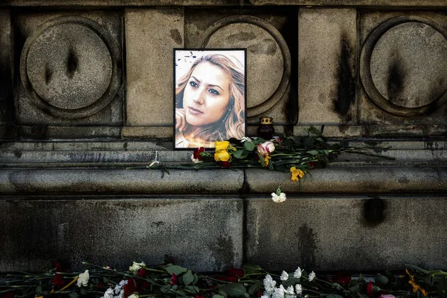 Flowers are placed near a portrait of slain Bulgarian television journalist Viktoria Marinova in the city of Rousse on October 9, 2018. Corruption- plagued EU member Bulgaria found itself under pressure to find the killer of a television journalist whose brutal murder at the weekend has shocked the country and sparked international condemnation. The body of 30- year- old Viktoria Marinova – who presented a current affairs talk programme called “Detector” for the small private TVN television in Ruse – was found on October 6, 2018. (Photo by Dimitar Dilkoff/AFP Photo)