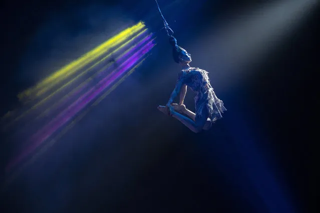 Performer Argentina Portugal flies through the big top while performing her act during the Paranormal Circus at the Ector County Coliseum Saturday, May 15, 2021, in Odessa, Texas. The Paranormal Circus will be in Odessa until May 23. (Photo by Eli Hartman/Odessa American via AP Photo)