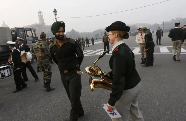 A member of the French military band (R) interacts with her Indian counterpart after the rehearsal for the “Beating the Retreat” ceremony in New Delhi, India, January 22, 2016. According to local media, a contingent of French soldiers will take part in the India's Republic Day parade along with the Indian troops in the presence of France's President Francois Hollande, who will be the chief guest this year. India celebrates its annual Republic Day on January 26. (Photo by Adnan Abidi/Reuters)