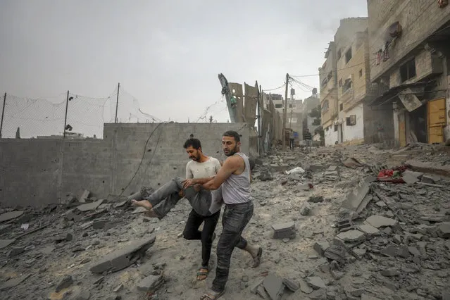 Palestinians evacuate wounded in Israeli aerial bombing on Jabaliya, near Gaza City, Wednesday, October 11, 2023 (Photo by Mohammad Al Masri/AP Photo)