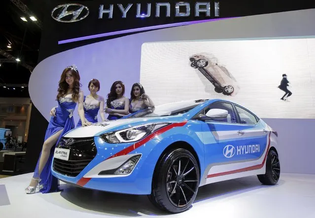 Models pose beside a Hyundai Elantra Sport during a media presentation of the 36th Bangkok International Motor Show in Bangkok March 24, 2015. (Photo by Chaiwat Subprasom/Reuters)