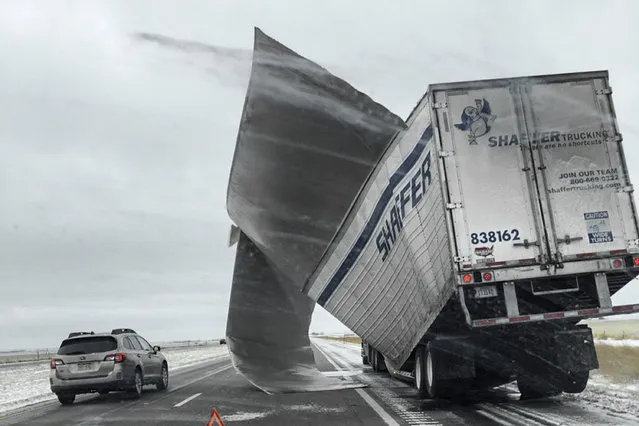 This November 25, 2018 photo which was released by the Nebraska State Patrol, shows a broken up trailer amid blowing snow on Interstate 80 near Bradshaw, Neb. Blizzard-like conditions have closed highways and delayed air travel as a winter storm moved through the Midwest. (Photo by Nebraska State Patrol via AP Photo)