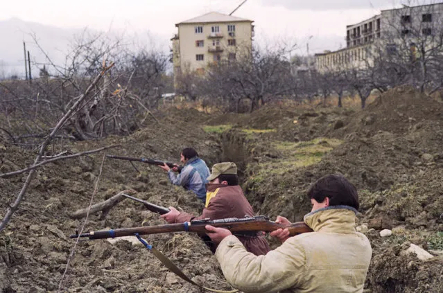 Ossetians in trenches on the outskirts of Tskhinvali, 1991. The men are using antiquated Russian Mosin-Nagant rifles first produced in the 1890s. Throughout 1991 the patchwork of Georgian and Ossetian villages that made up South Ossetia was riven with interethnic murders and intimidation. (Photo by Gennady Khamelyanin/ITAR-TASS)